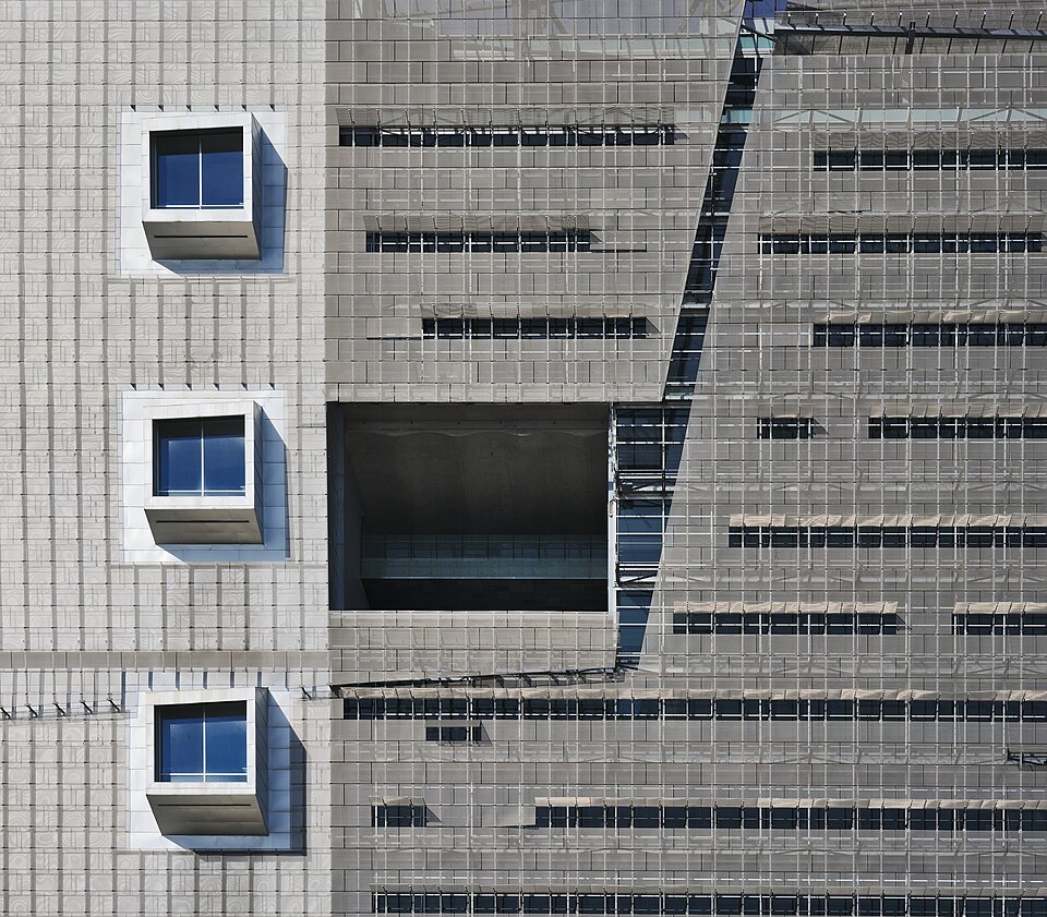Tensioned metal mesh façade — representative photo